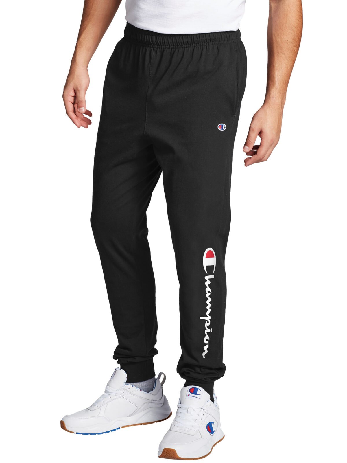 The Champion Men's Classic Jersey Graphic Script Logo Jogger Pants are a comfortable and stylish option for casual wear. Made from soft jersey fabric, these jogger pants feature the iconic Champion script logo prominently displayed, adding a touch of sporty flair. They are designed with an elastic waistband and adjustable drawcord for a secure fit, along with ribbed cuffs to ensure the pants stay in place. Perfect for lounging, workouts, or everyday wear, these jogger pants combine comfort and fashion effortlessly. Champion Men's Classic Jersey Graphic Script Logo Jogger Pants